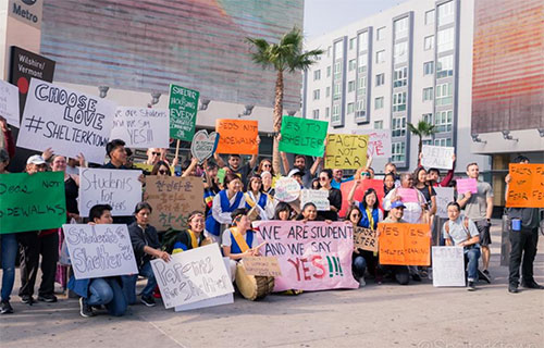 Counter-protesters pose together at the Wilshire/Vermont Metro stop.