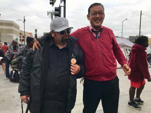 Pastor Tim Park poses with David Sanchez, after giving him his jacket for taking on a challenge to recite the Ten Commandments.