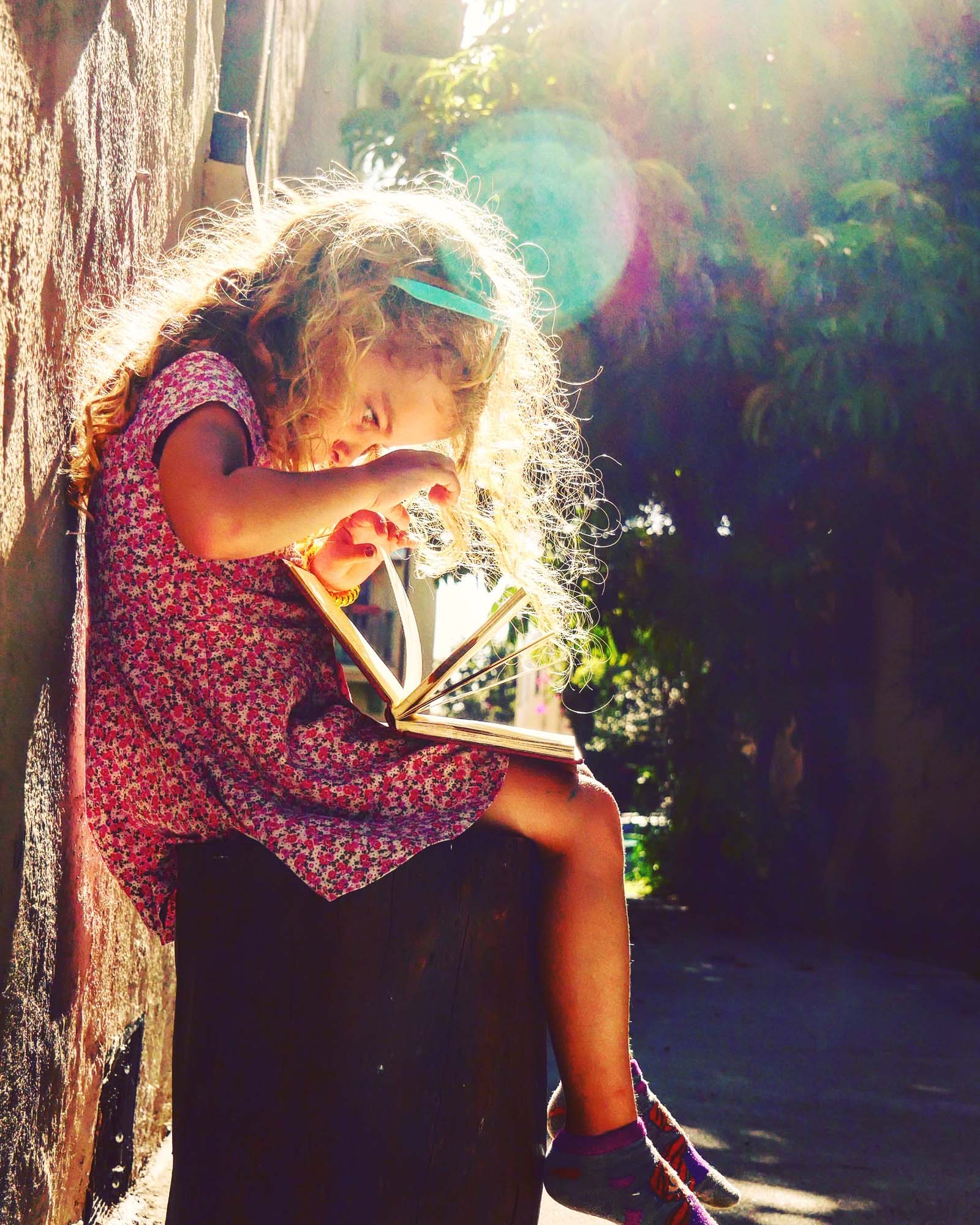 “Betty in Wonderland.” Betty Angel looking through her grandfather’s edition of “Alice in Wonderland.