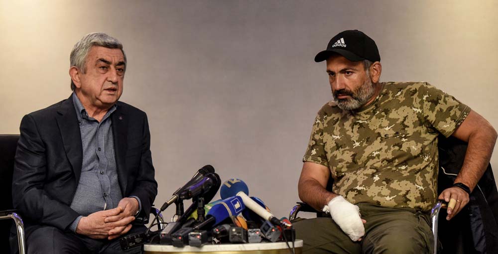 Armenian Prime Minister Serzh Sargysan (left) meets with anti-government protest leader Nikol Pashinyan (right) at the start of a televised meeting, that he left shortly after it began, in a Yerevan hotel on April 22, 2018.