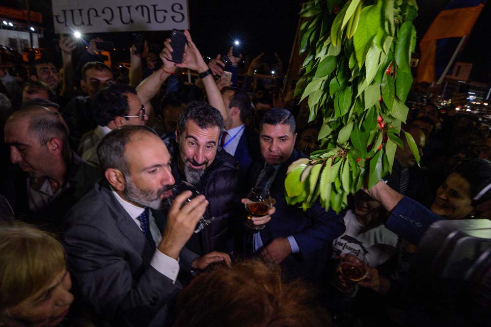 Armenian opposition leader Nikol Pashinyan and his supporters welcome Serj Tankian, the Armenian-American leader of the band System Of A Down, on his way to Yerevan's Republic Square on May 7, 2018.