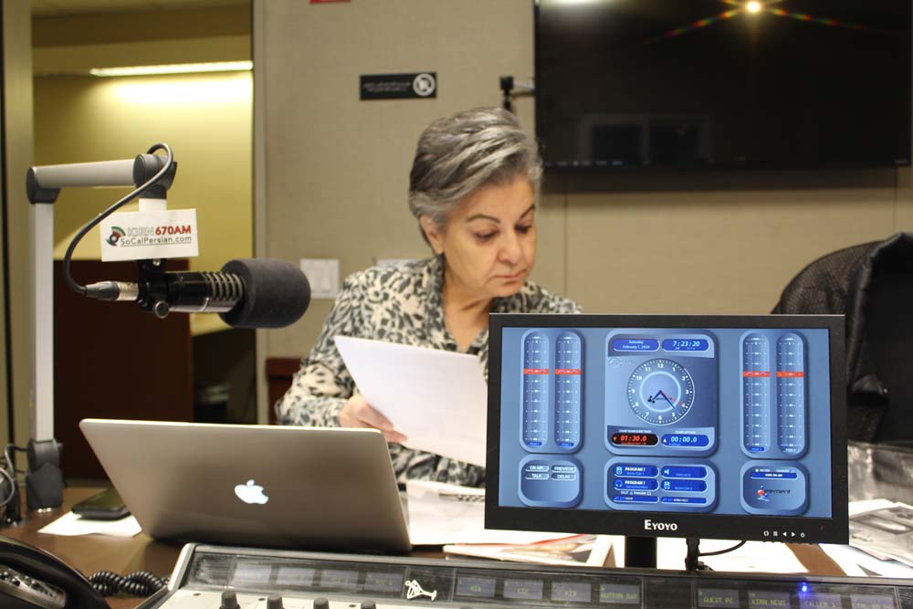 Homa Sarshar prepares notes prior to the broadcast of her weekly Persian-language radio show, “Breakfast with Homa Sarshar,” on Southern California's KIRN Radio Iran.