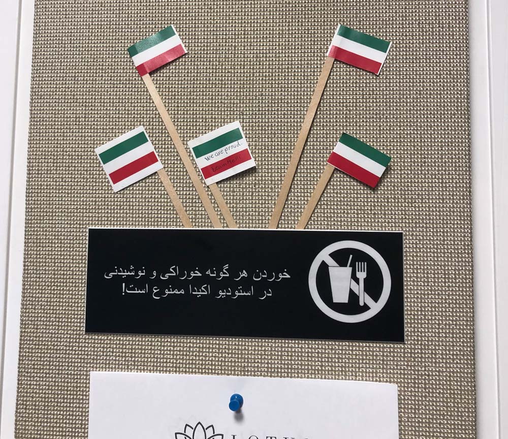 The bulletin board in Homa Sarshar's radio control room at KIRN Radio Iran in Universal City displays flags of Iran and a warning not to eat or drink in the studio.