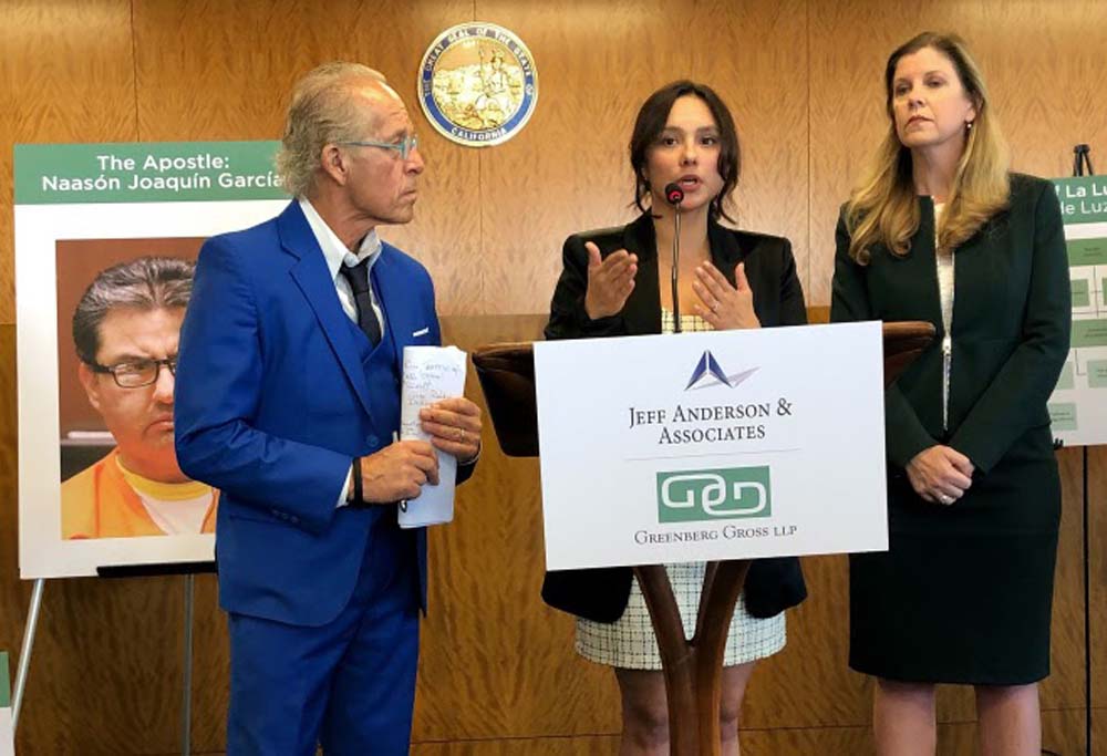 Sochil Martin, center, with lawyers Jeff Anderson, left, and Deborah Mallgrave, speaks at a news conference in Los Angeles Thursday, Feb. 13, 2020. Martin has filed a federal lawsuit claiming that the leaders of Mexican megachurch La Luz del Mundo sexually abused her since she was 12 years old.