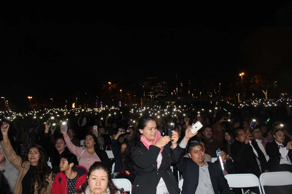 In December 2019, La Luz Del Mundo members in Los Angeles hold up their cellular devices during a large gathering in Grand Park celebrating their 'apostle.'