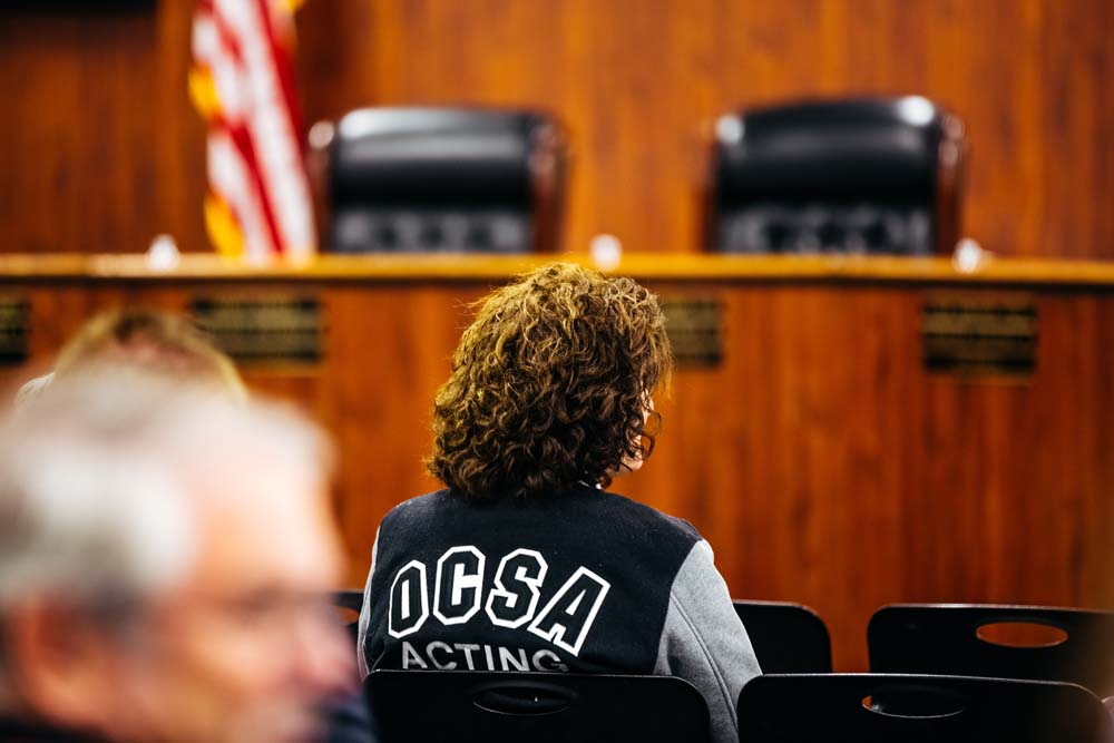 An OCSA supporter wears a school letterman jacket to a Feb 5. meeting of the Orange County Board of Education in Costa Mesa.