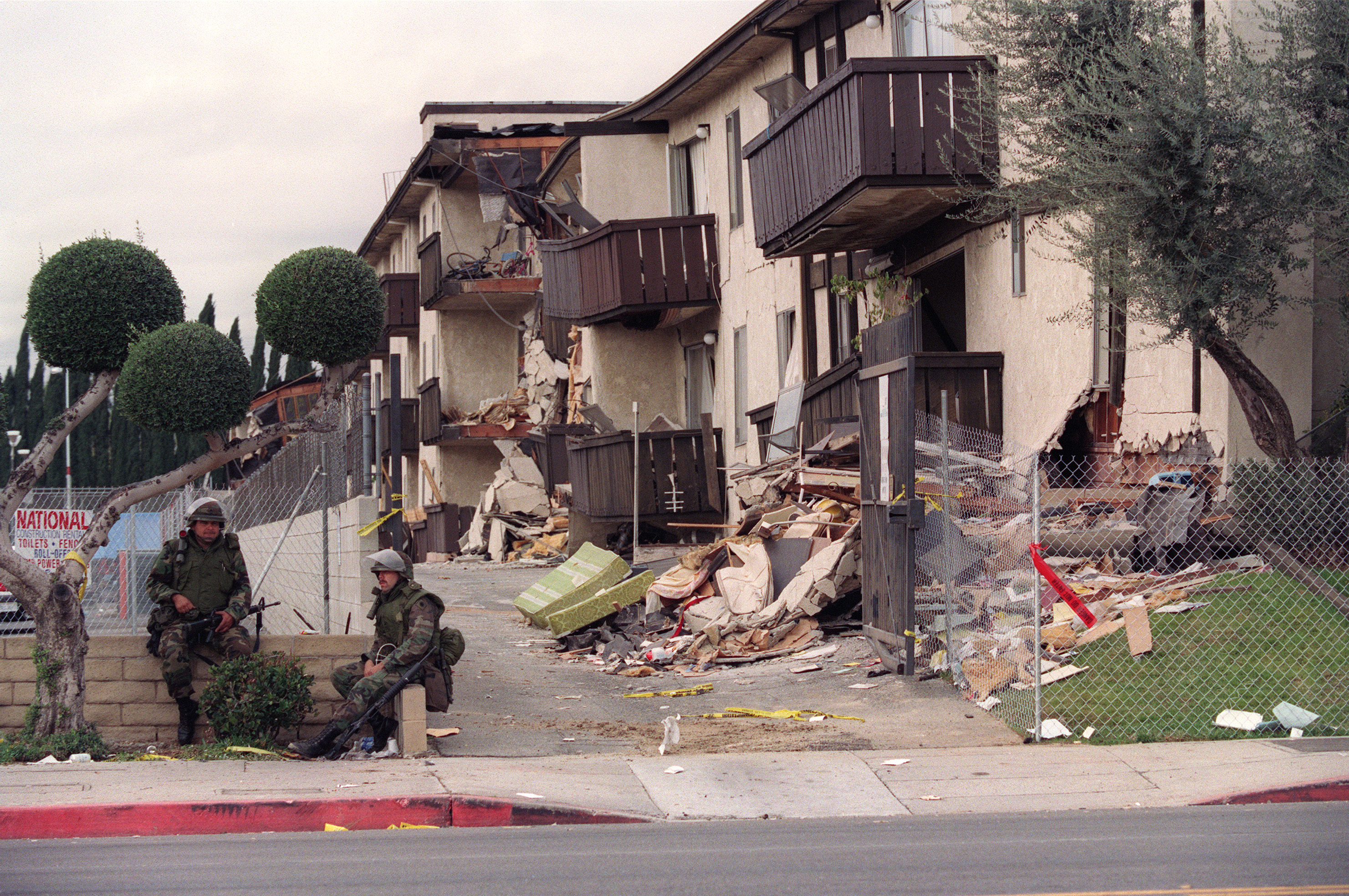 National Guard soldiers are posted in front of the Northridge Meadows apartments one week after 16 people died during an earthquake on Jan. 17, 1994. Residents were allowed to enter the condemned building for 15 minutes at a time to collect personel effects.